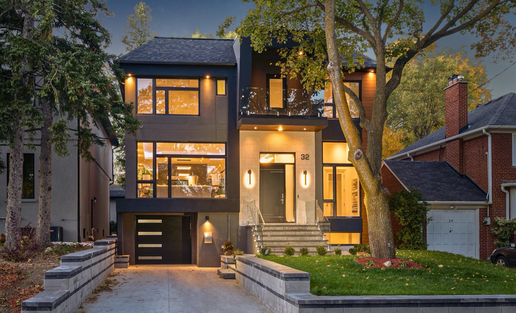 Modern custom home in Toronto built by Atena, lit at dusk