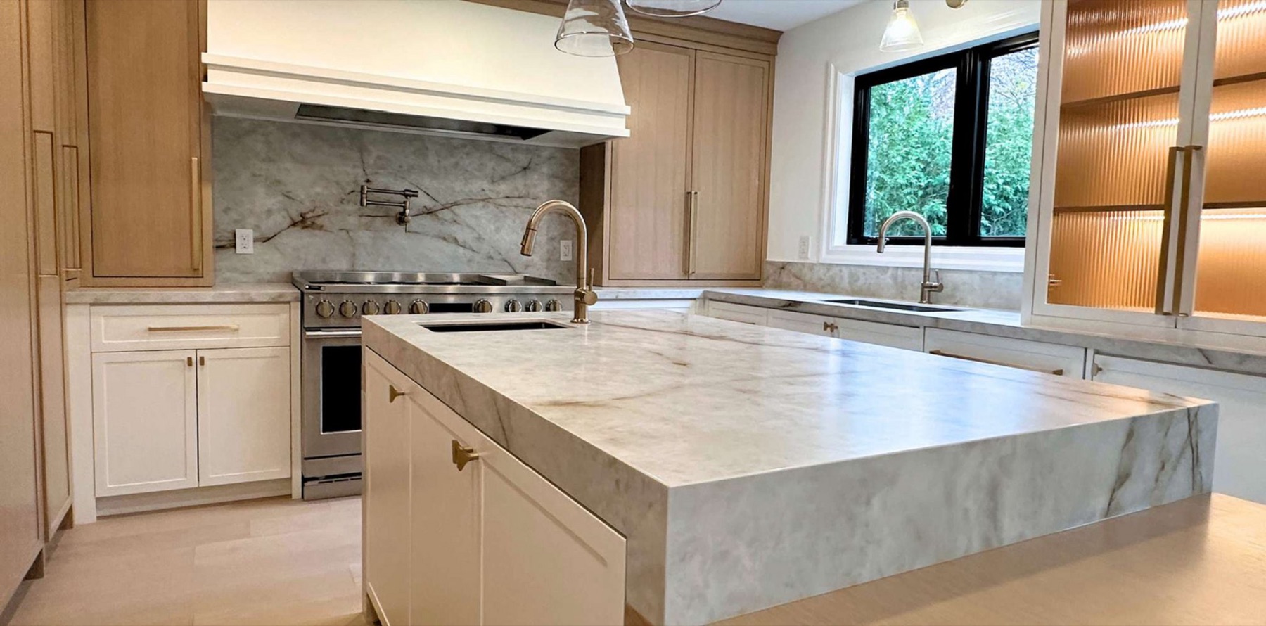 Marble waterfall island — custom kitchen, Toronto